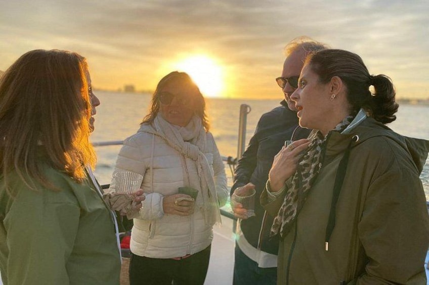 A group of people on a boat during sunset. 2