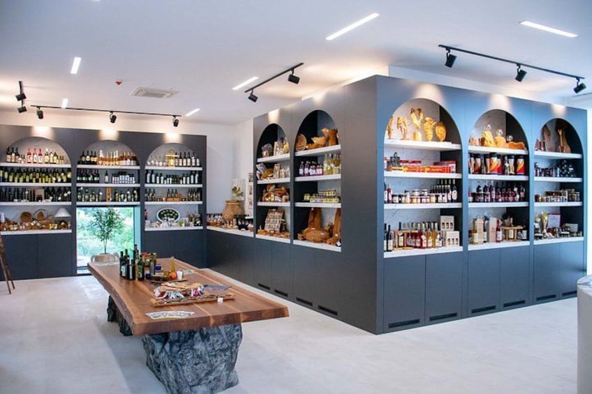 A modern bar with shelves of liquor bottles, a marble bar counter, and arched shelving units. 1