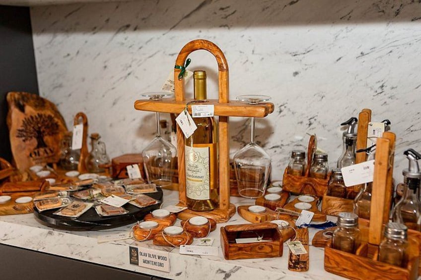 A display of wooden items including a wine bottle, glasses, and various containers. 5