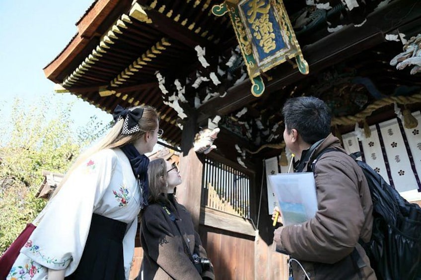 A traditional Japanese building with a wooden structure and a hanging lantern. 4