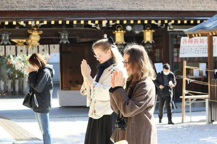 A traditional Japanese building with a thatched roof, a wooden entrance, and a signboard. 3