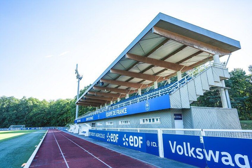 A stadium with a running track, bleachers, and advertising banners. 2