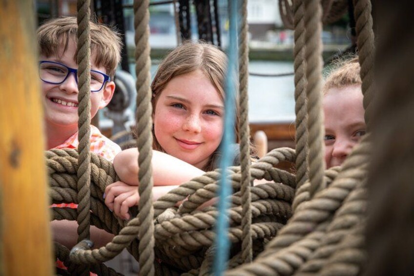 Children playing on a rope climbing structure. 4