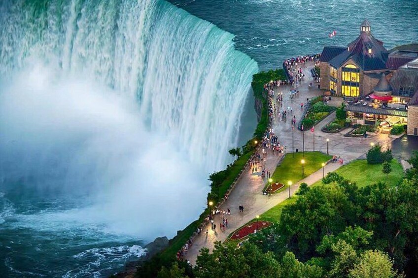 A large waterfall, a viewing platform, and a building with a pointed roof. 3