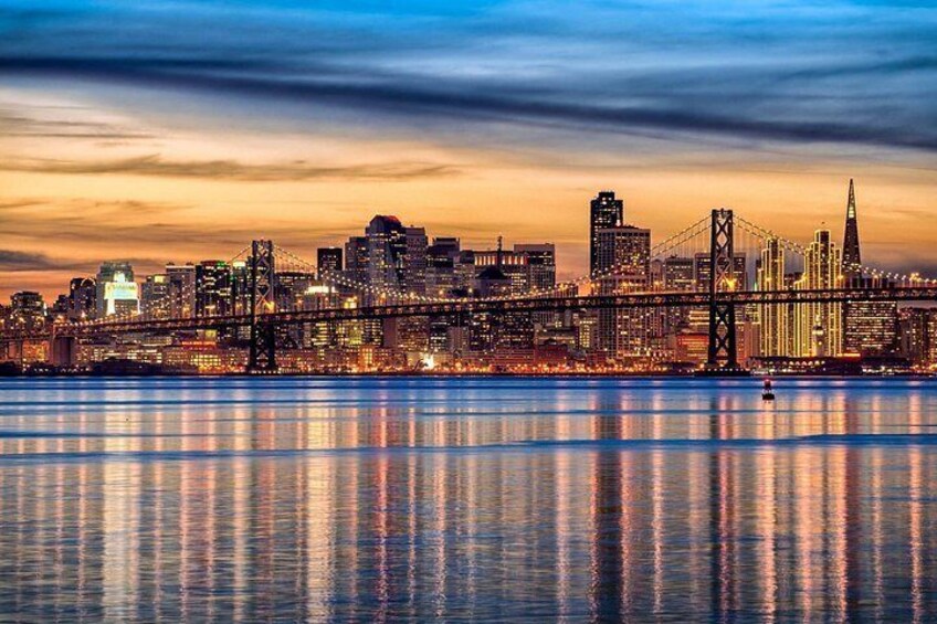 A city skyline with a prominent bridge and skyscrapers reflecting on the water. 2