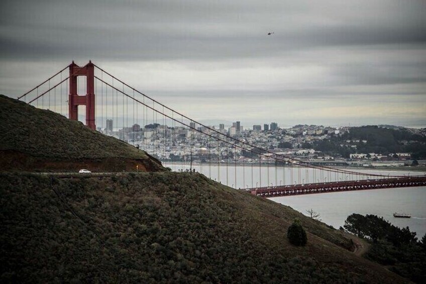 The Golden Gate Bridge with a cityscape in the background. 1