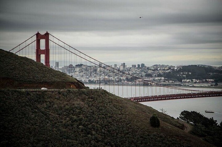 The Golden Gate Bridge, a red suspension bridge, with a cityscape in the background. 3