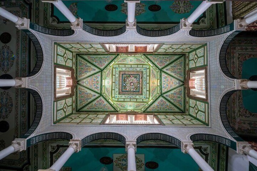 A detailed ceiling with geometric patterns and a central medallion. 2