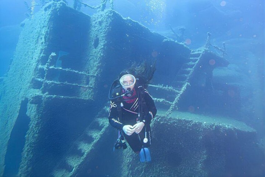 A diver exploring an underwater shipwreck. 4
