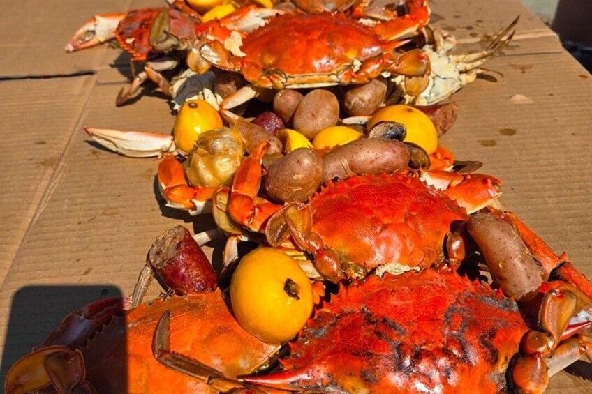 A table with cooked crabs and lemons. 2