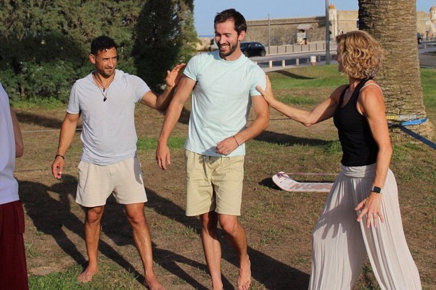 Three people walking in a park, holding hands. 2