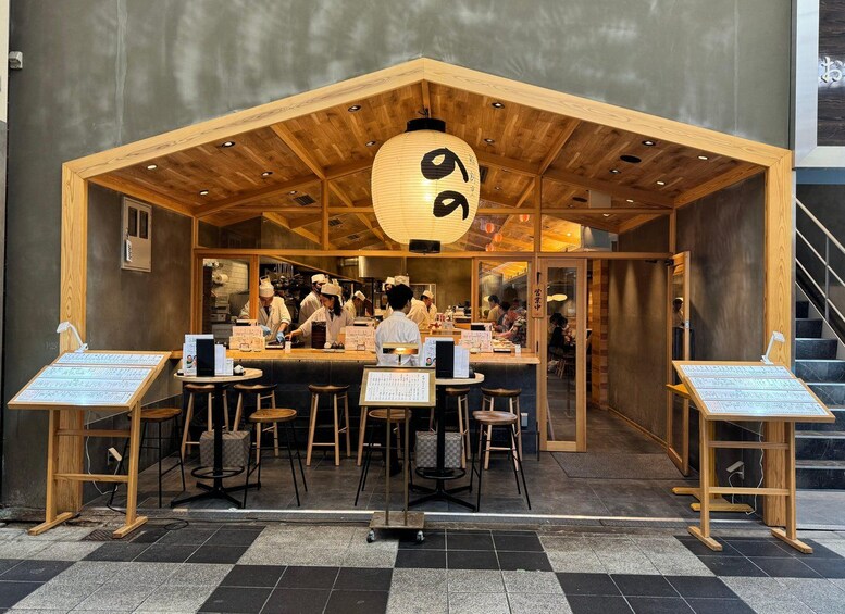 A traditional Japanese restaurant with a wooden exterior and a large lantern. 5