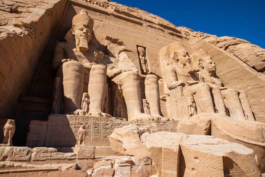 A large rock-cut temple with statues of pharaohs and hieroglyphs. 5