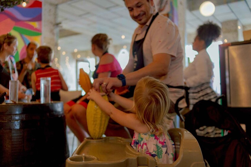 A person squeezing a lemon over a bowl. 1
