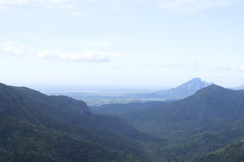 A mountainous landscape with a valley and distant mountains. 5
