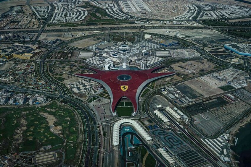 An aerial view of a complex transportation hub with multiple roads and a distinctive red structure at the center. 4