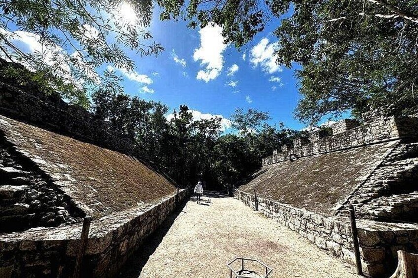 An ancient stone structure with a pathway leading through it. 5