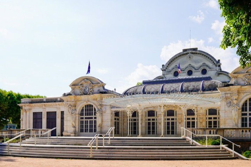 A classical building with a dome, columns, and steps leading to the entrance. 2