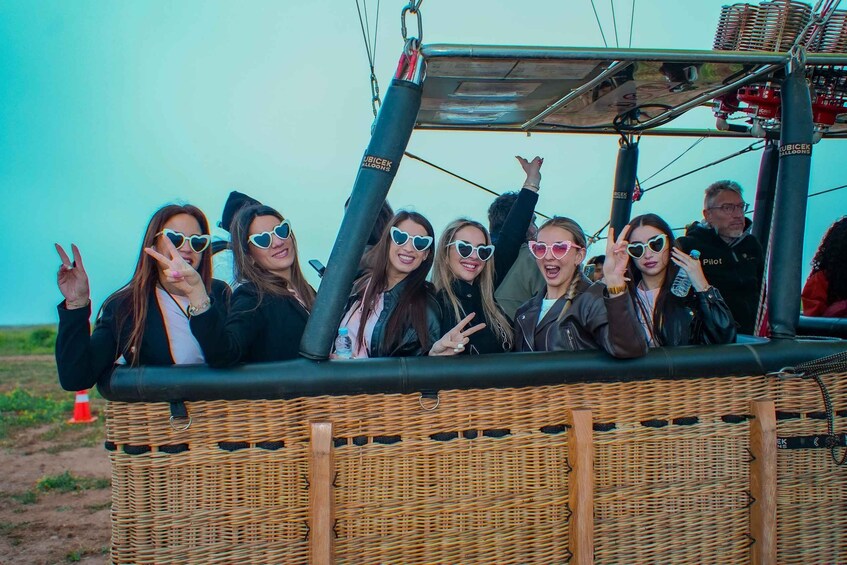 A wicker boat with people wearing sunglasses and making peace signs. 5