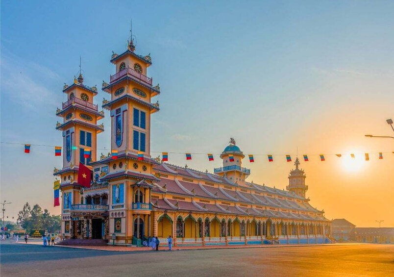 A large, ornate building with multiple towers and a central dome, surrounded by a wide open plaza. 1