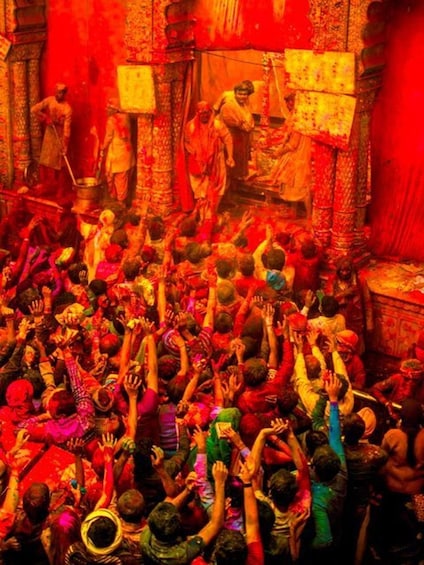 A crowded indoor scene with people participating in a ritual, surrounded by ornate architecture. 3
