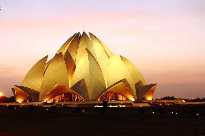 A large, lotus-shaped building with multiple tiers and golden lighting. 2