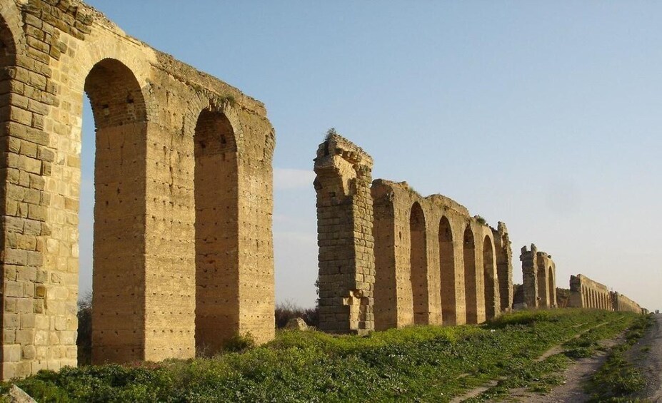 Ancient stone arches along a rural road. 3