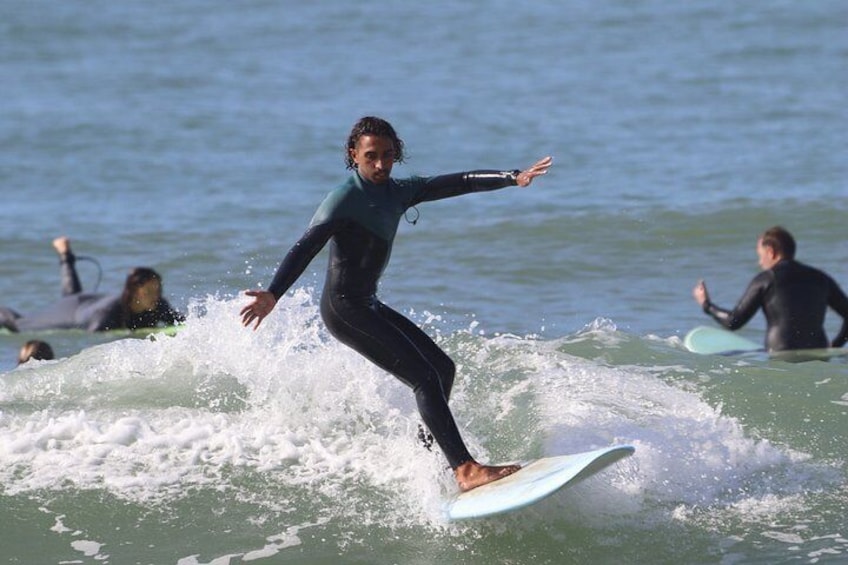 A person surfing on a wave in the ocean. 1