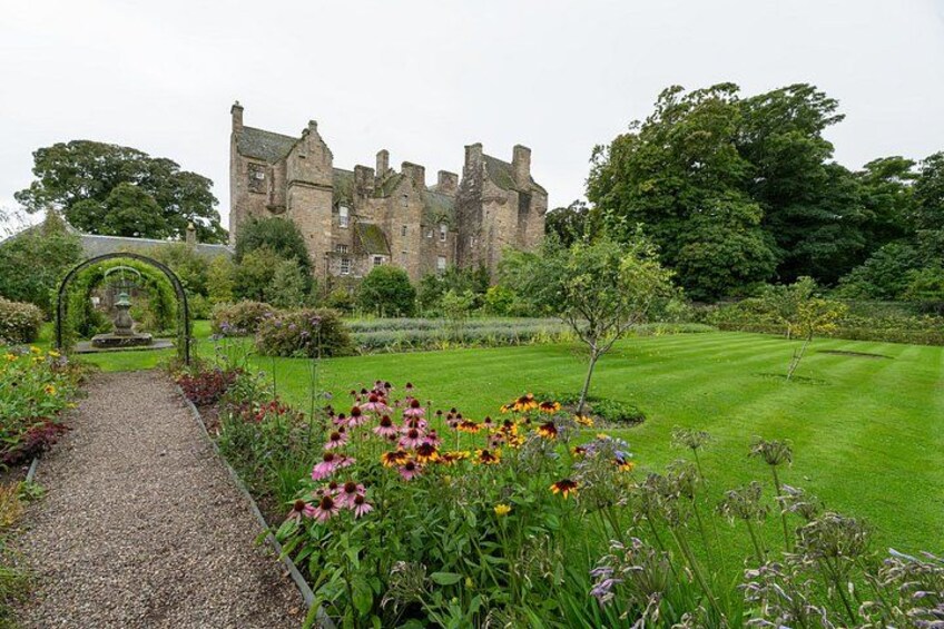 A castle, a garden pathway, and a variety of flowers. 2