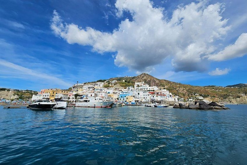 A coastal village with colorful buildings, boats, and a mountainous backdrop. 5