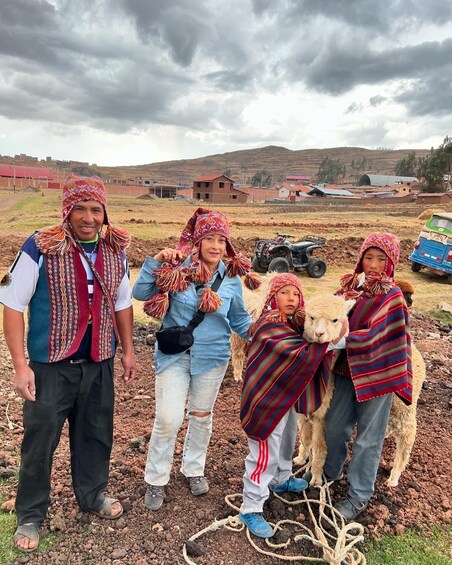 A group of people with llamas in a rural setting. 4