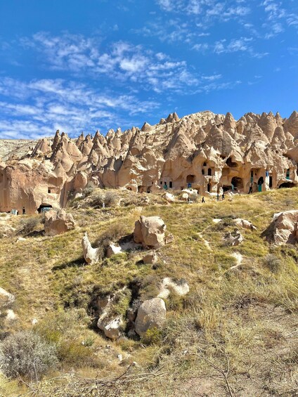 A landscape with rock formations and cave dwellings. 4