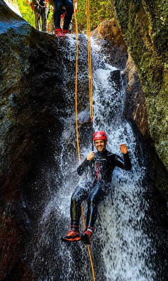 A person rappelling down a waterfall. 3