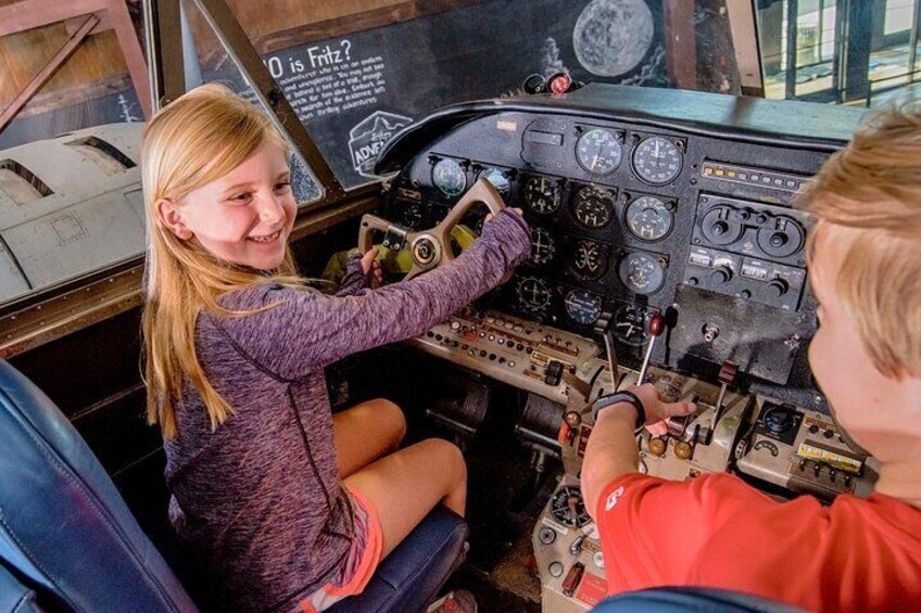 Suspended 1959 Twin Beech airplane, also known as the Beechcraft Super 18, with functioning flaps and rudder pedals.