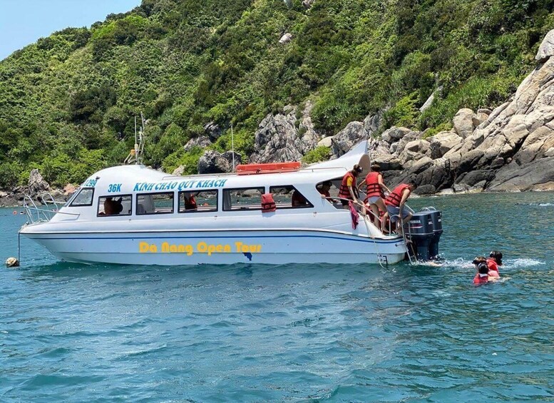 A boat with people wearing life jackets, preparing to disembark. 1
