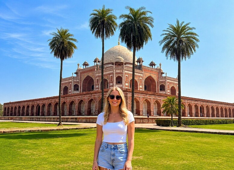 A large, historic building with a dome and arched windows, surrounded by palm trees and a well-maintained lawn. 4