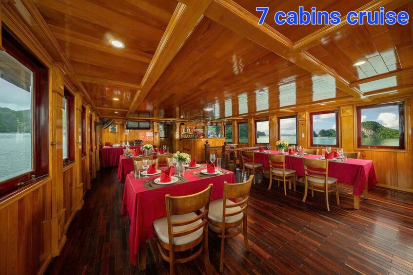 A cruise ship dining area with wooden interiors and tables set for dining. 3
