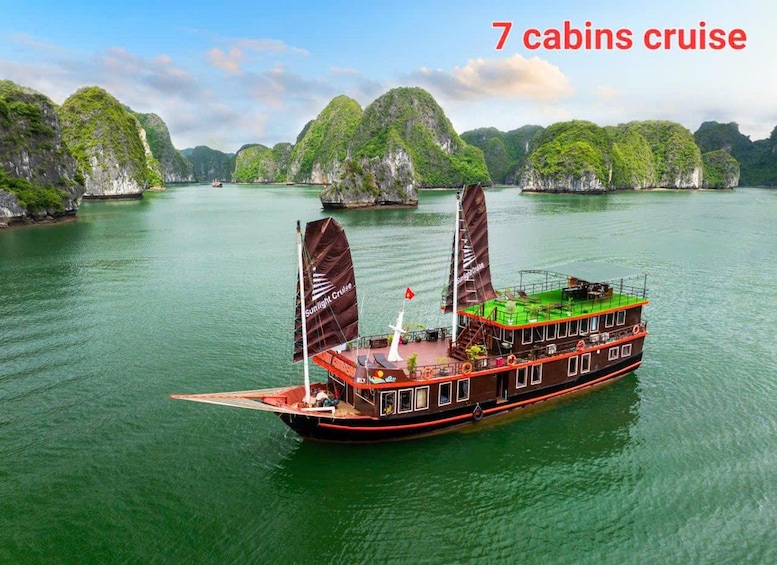 A 7-cabins cruise boat on a calm river surrounded by lush green islands. 5