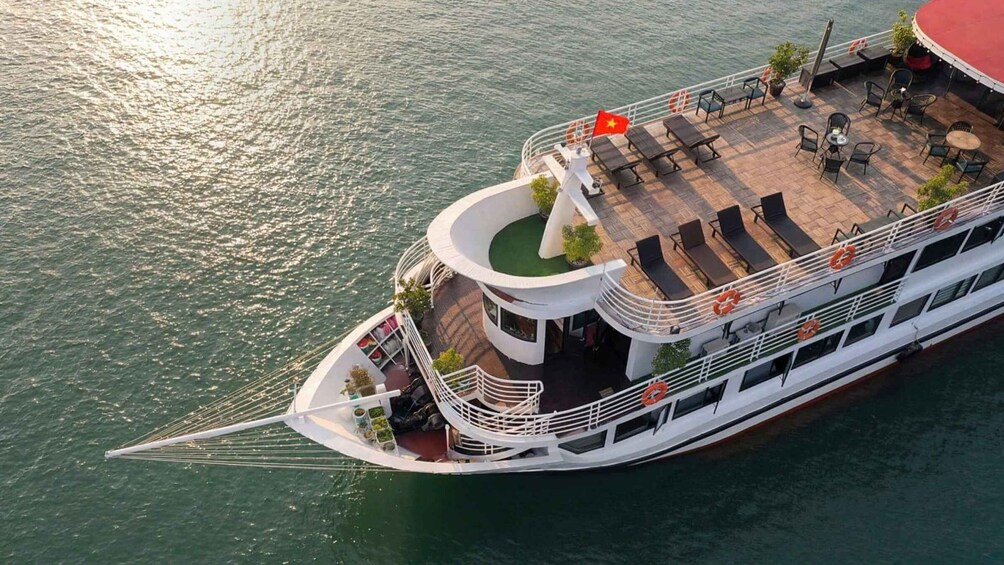 A riverboat with a circular deck, lounge chairs, and a flag. 5
