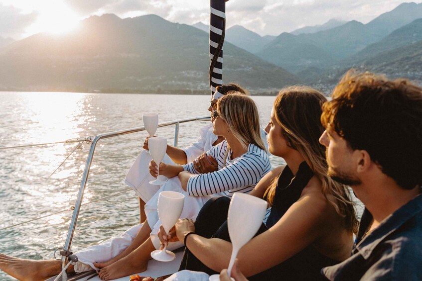 A group of people on a boat with a mountainous landscape in the background. 5