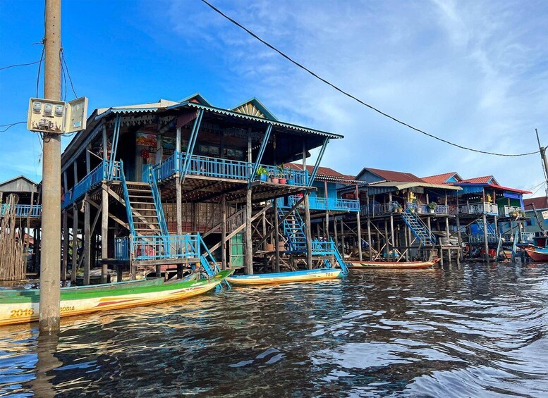 A floating village with wooden houses and boats. 4