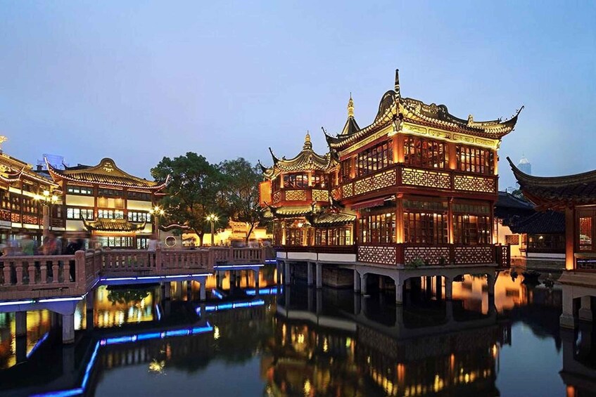 A traditional Chinese courtyard with ornate buildings and a reflective water feature. 2