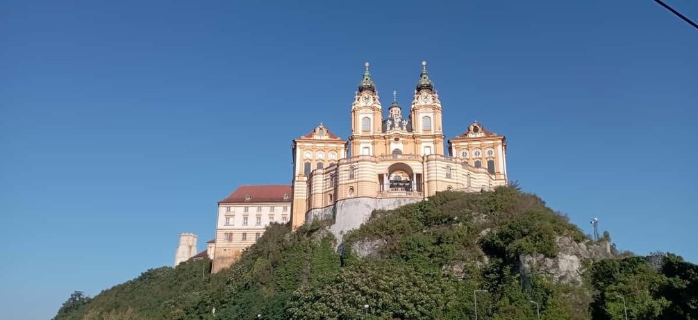 A large, ornate church with three towers on a hill. 1