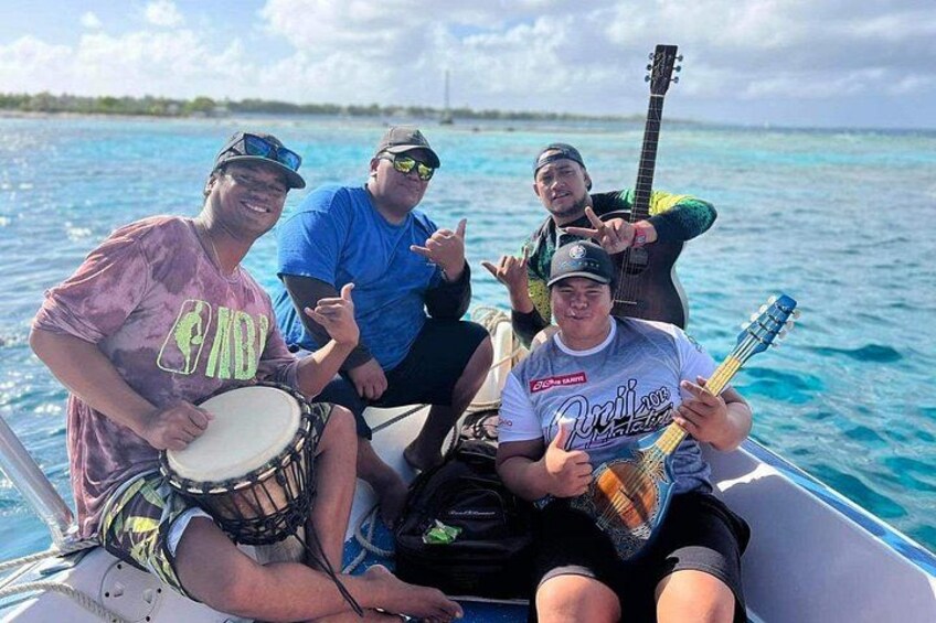 Four people on a boat, two playing drums, one playing guitar, and one holding a microphone. 4