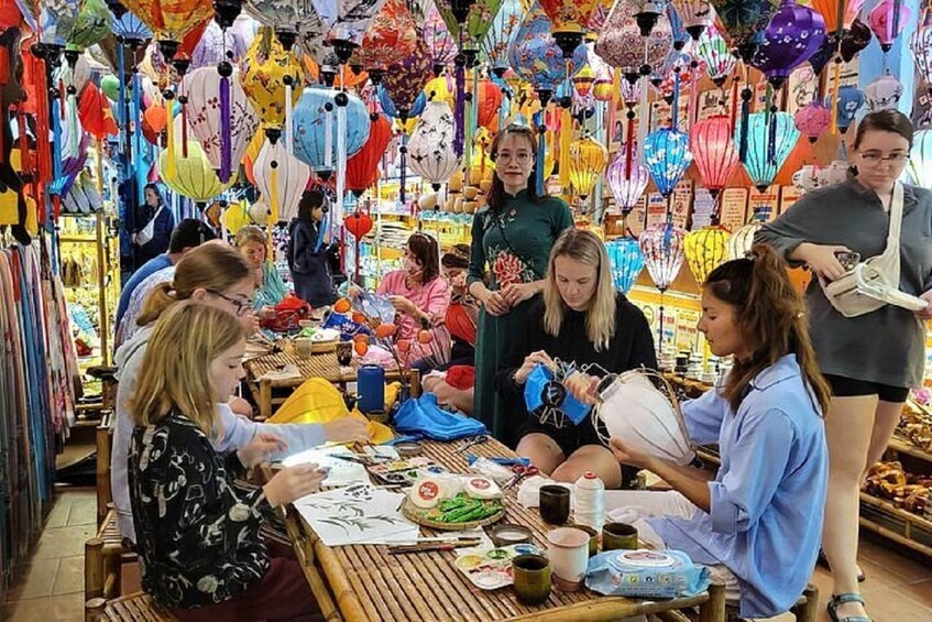 A market with colorful lanterns and people engaged in various activities. 1