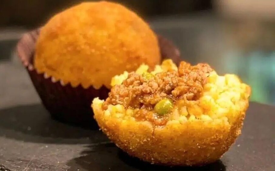 Two muffins, one whole and one cut in half, with visible filling and topping. 4