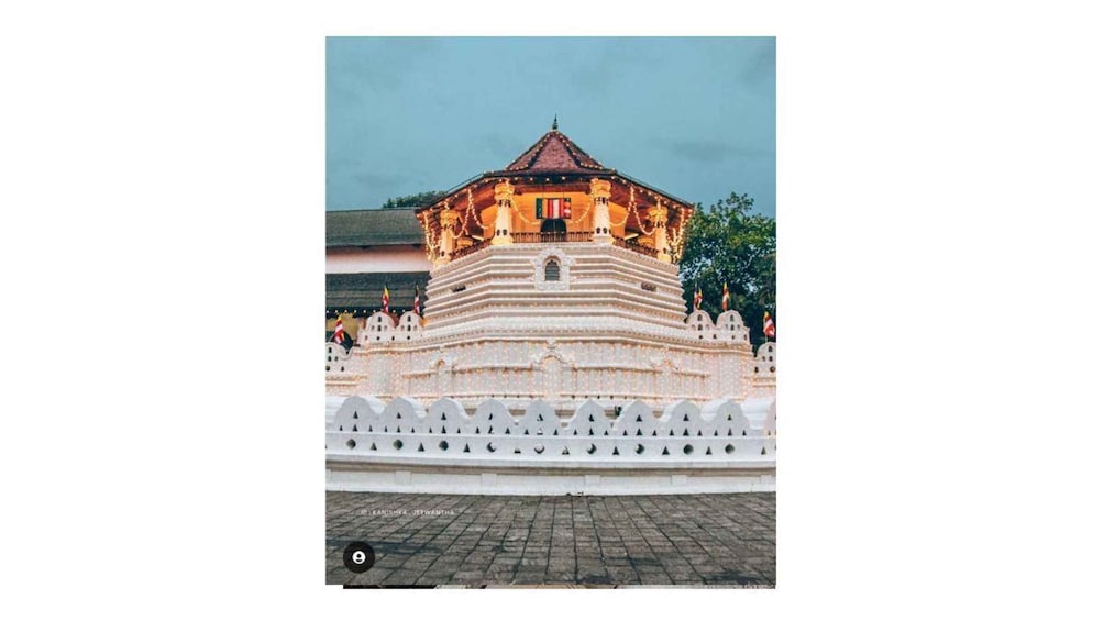 A temple with a tiered roof and multiple flags. 1