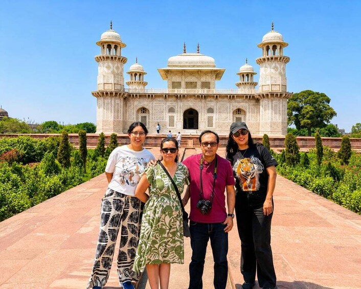 A group of people standing in front of a large, ornate building with domes and minarets. 5