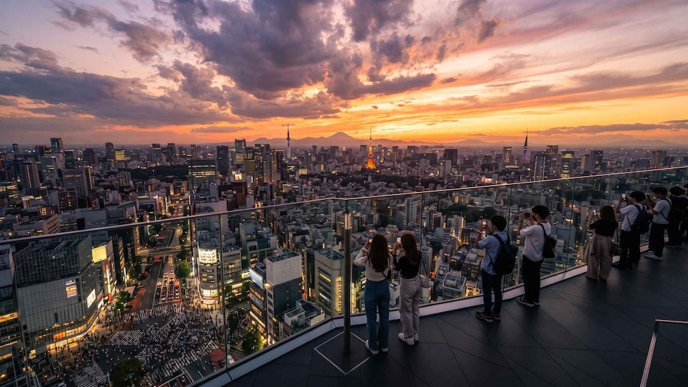 A cityscape at sunset with a group of people taking photos. 5