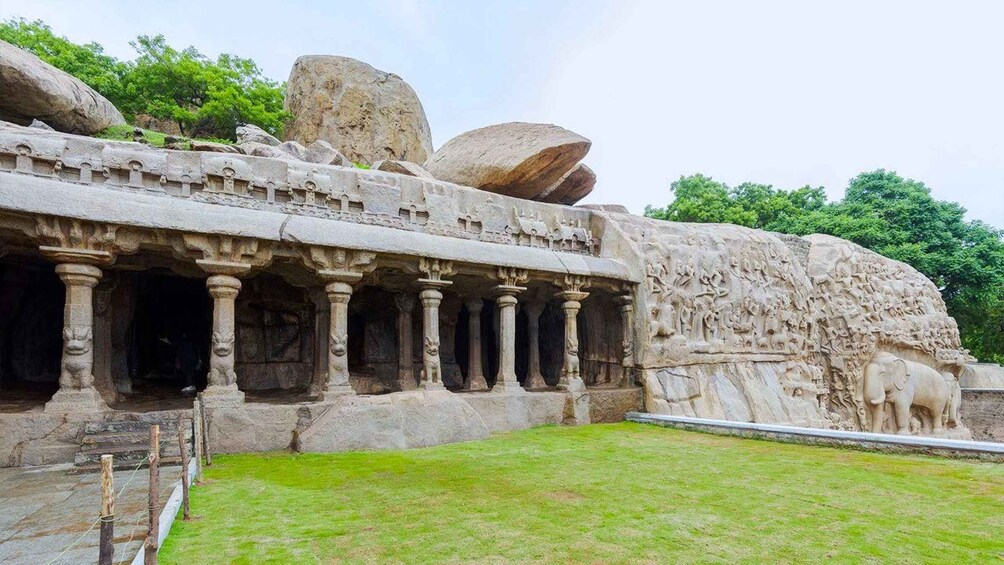 A stone structure with carved pillars and a relief sculpture of elephants. 1